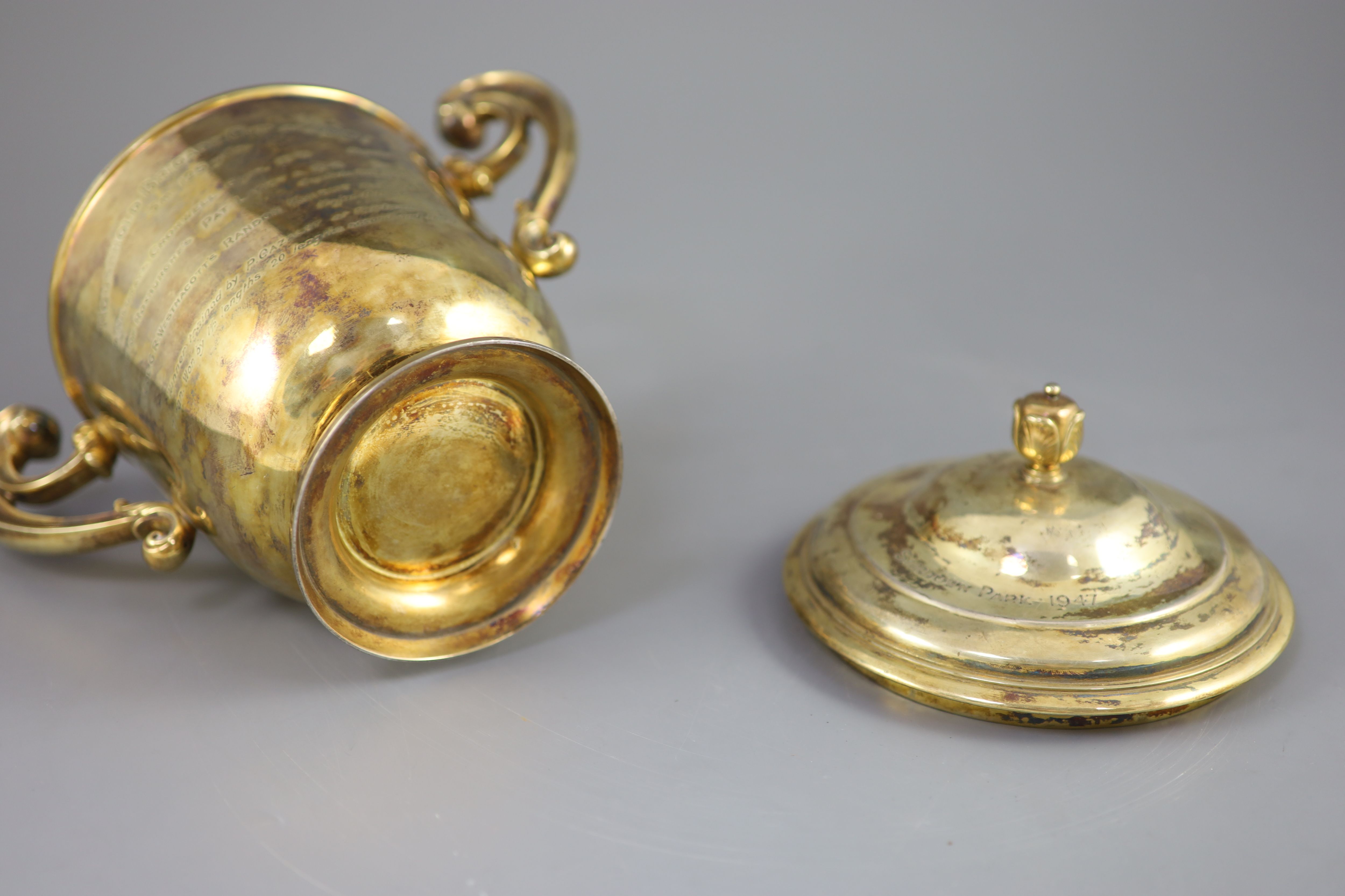 An Edwardian silver gilt-lidded two handled presentation cup and cover, by R & S Garrard and Co.